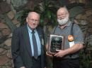 AWA Houck Awards Administrator Barney Wooters, W5KSO, presents the Houck Award for Documentation to John Dilks, K2TQN. [Photo, Bill Zukowski, N2YEG]