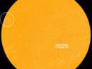 New sunspots are emerging at the circled location. They are crackling with C-class solar flares. [Photo courtesy of NASA SDO/HMI]