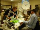 ARRL Test Engineer Bob Allison, WB1GCM, assists two USTTI participants with their receiver kit. [S. Khrystyne Keane, K1SFA, Photo]